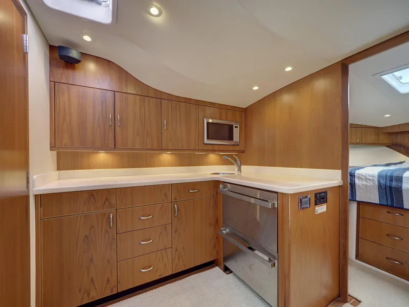 Slide: The Image of Luxurious 2013 Cabo HTX yacht interior with modern kitchen and wood cabinetry. - 9