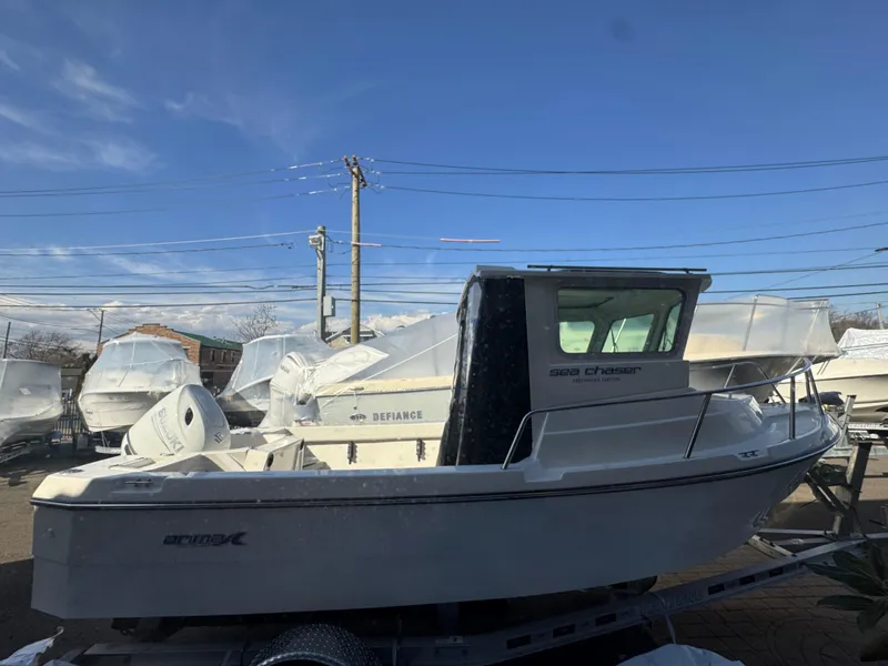 Slide: The Image of 2025 Arima Sea Chaser 19 Yellowtail Edition boat on display under clear blue sky. - 20