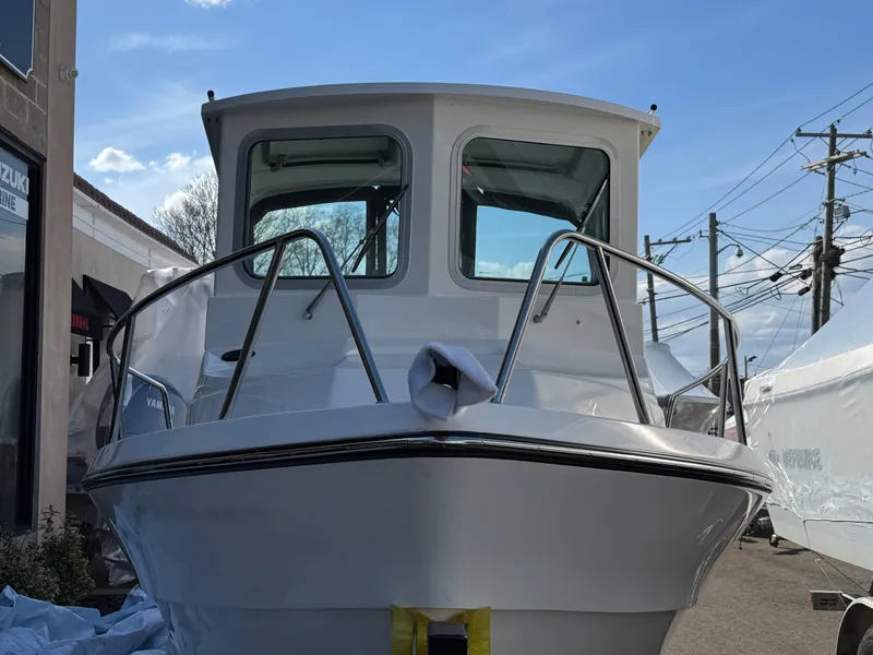 Slide: The Image of 2025 Arima Sea Chaser 19 Yellowtail Edition boat, front view, docked outdoors. - 21