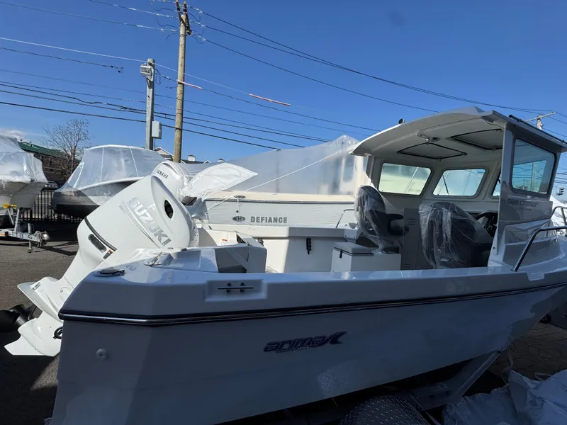 Slide: The Image of 2025 Arima Sea Chaser 19 Yellowtail Edition boat, white exterior, parked outdoors. - 3