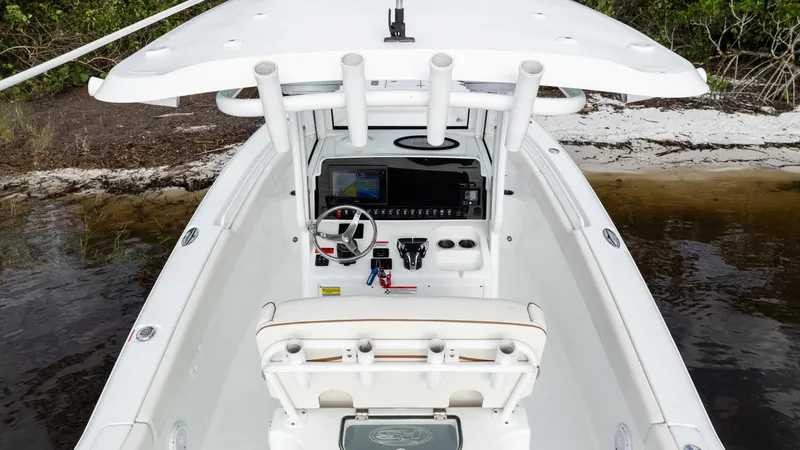 Slide: The Image of 2021 Sea Hunt Gamefish 25 boat cockpit with steering wheel and controls. - 1