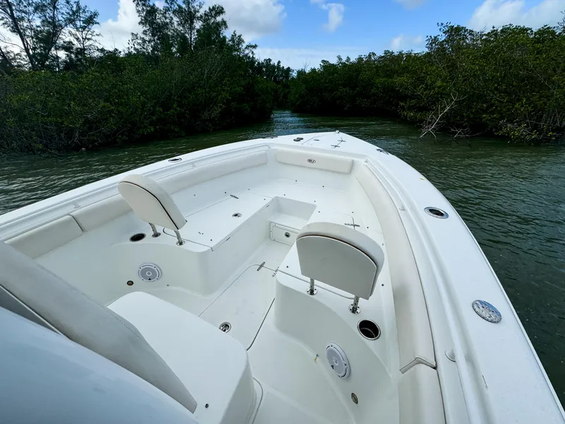 Slide: The Image of 2021 Sea Hunt Gamefish 25 boat navigating through lush mangrove waters. - 11