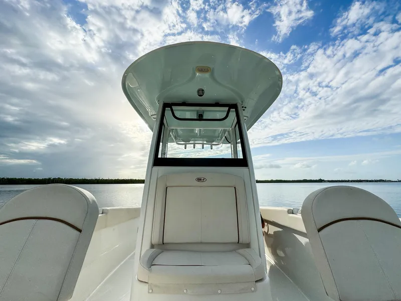 Slide: The Image of 2021 Sea Hunt Gamefish 25 boat interior with clear sky and water view. - 14
