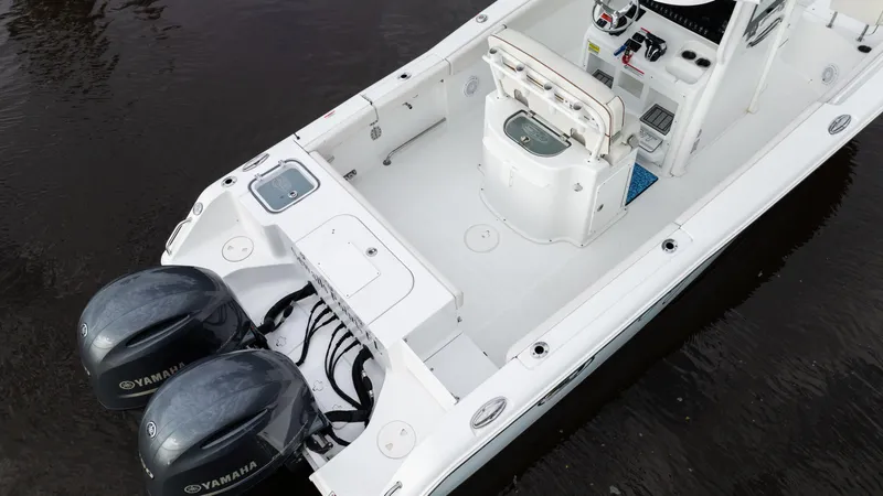 Slide: The Image of 2021 Sea Hunt Gamefish 25 boat with dual Yamaha engines on water. - 22