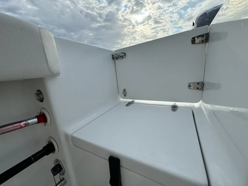 Slide: The Image of 2021 Sea Hunt Gamefish 25 boat interior with storage compartment under cloudy sky. - 24