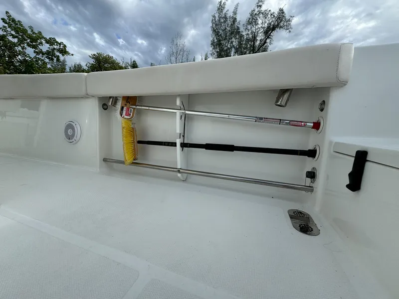 Slide: The Image of 2021 Sea Hunt Gamefish 25 boat interior with rod storage and safety equipment. - 26