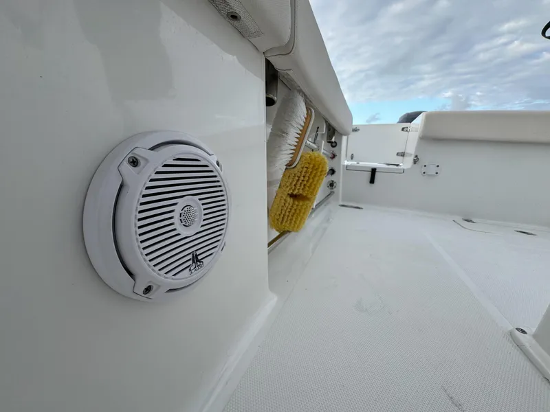 Slide: The Image of 2021 Sea Hunt Gamefish 25 boat deck with speaker and cleaning brush. - 27