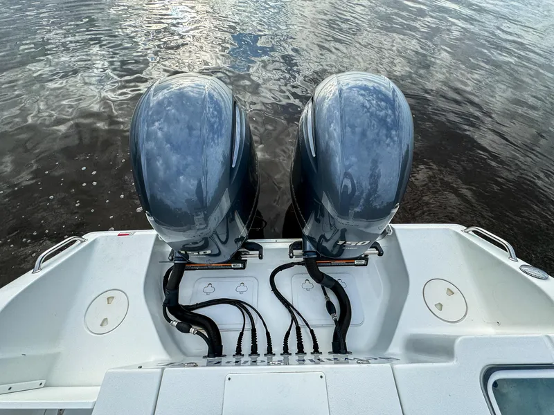 Slide: The Image of 2021 Sea Hunt Gamefish 25 with dual outboard motors on calm water. - 28