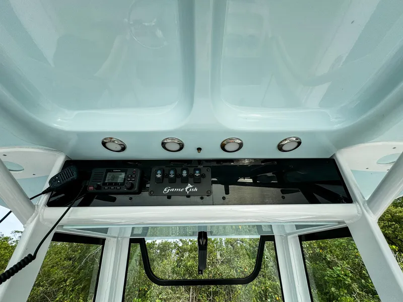Slide: The Image of 2021 Sea Hunt Gamefish 25 boat console with controls and radio. - 3
