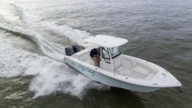Slide: The Image of 2021 Sea Hunt Gamefish 25 boat cruising on open water. - 31