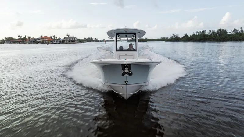 Slide: The Image of 2021 Sea Hunt Gamefish 25 boat cruising on a calm lake. - 32