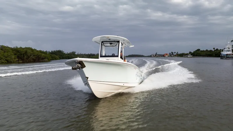 Slide: The Image of 2021 Sea Hunt Gamefish 25 cruising on a river under cloudy skies. - 35