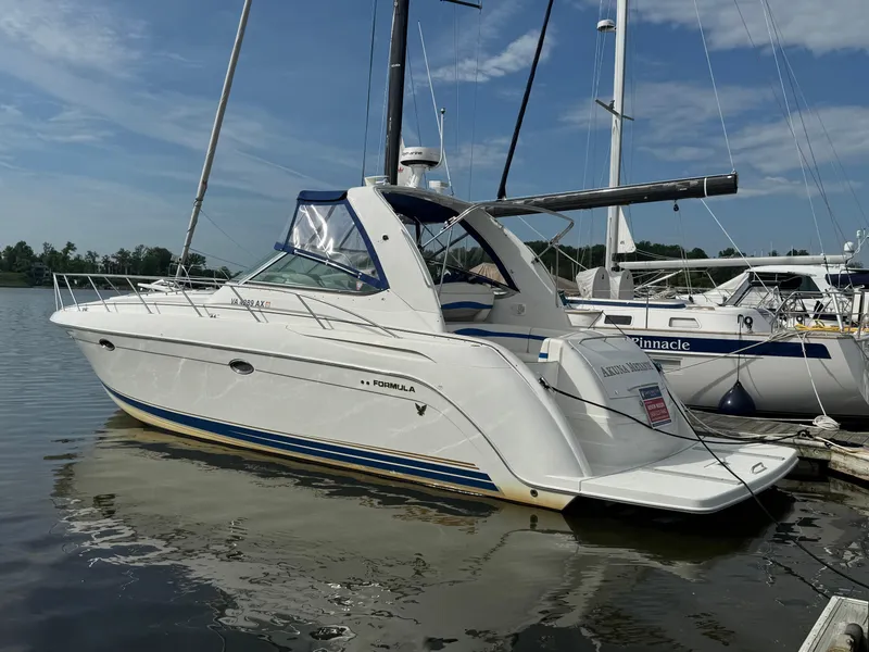 The Image of 2001 Formula 40 Performance Cruiser docked at marina under clear sky. - 0