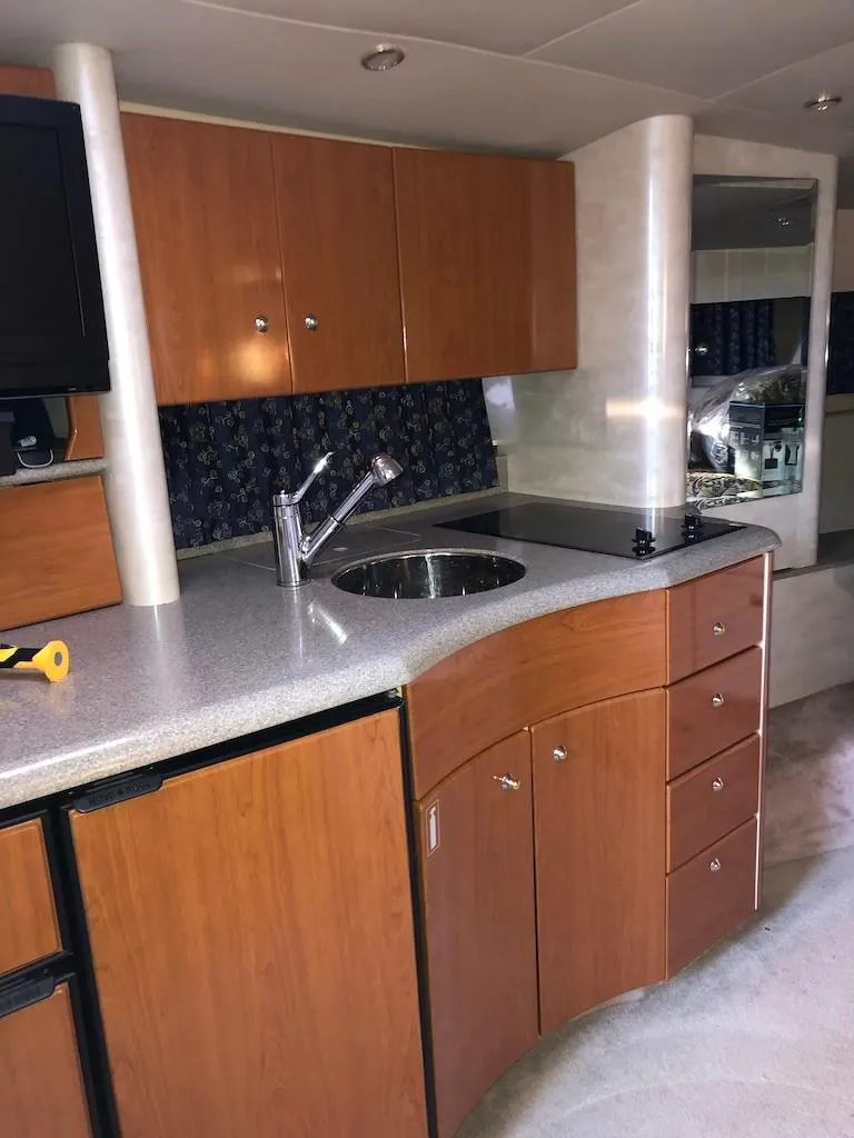 Slide: The Image of 2001 Formula 40 Performance Cruiser kitchen with wood cabinets and modern fixtures. - 11