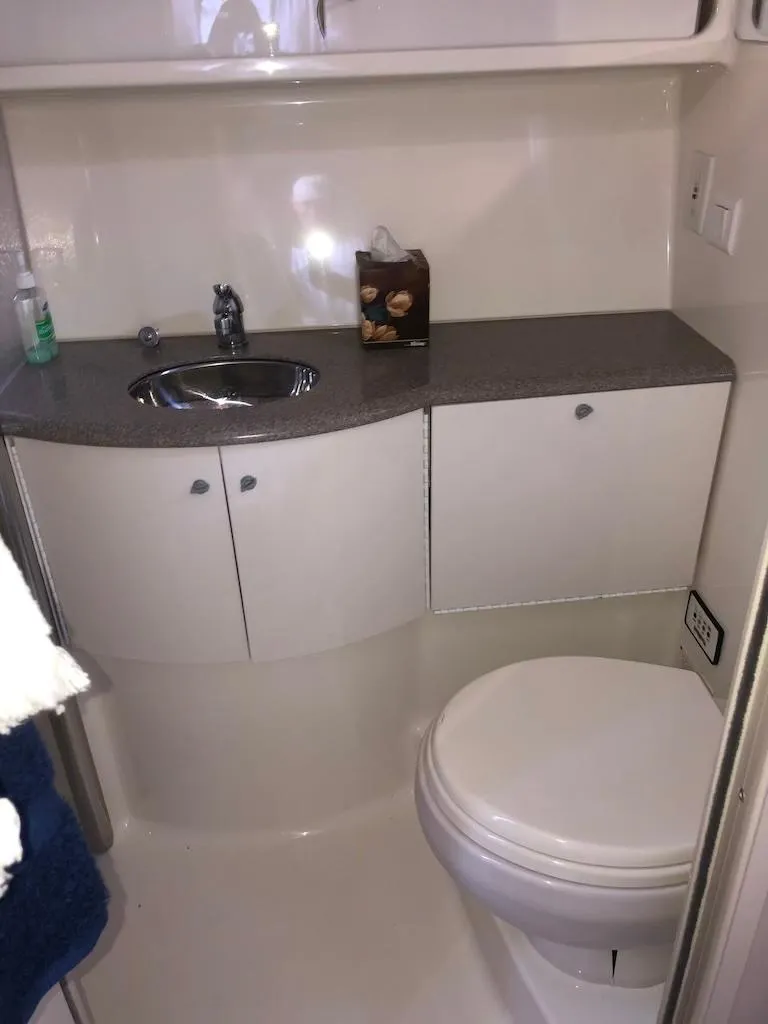 Slide: The Image of 2001 Formula 40 Performance Cruiser bathroom with sink, cabinets, and toilet. - 13