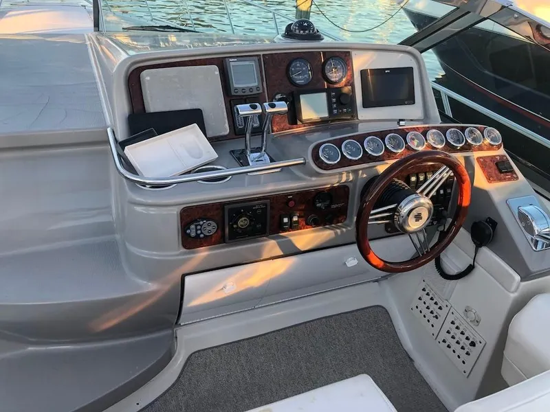 Slide: The Image of 2001 Formula 40 Performance Cruiser helm with gauges, steering wheel, and navigation equipment. - 2