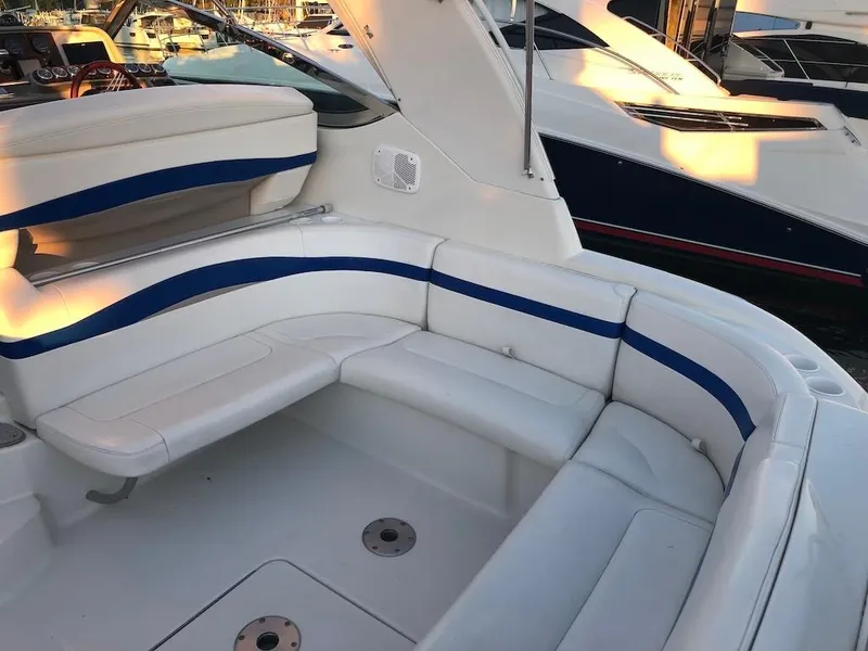 Slide: The Image of 2001 Formula 40 Performance Cruiser with white and blue seating in a marina setting. - 3