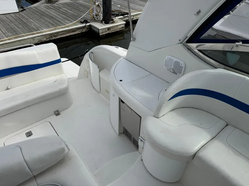 Slide: The Image of 2001 Formula 40 Performance Cruiser interior with white seating and blue accents at a dock. - 4