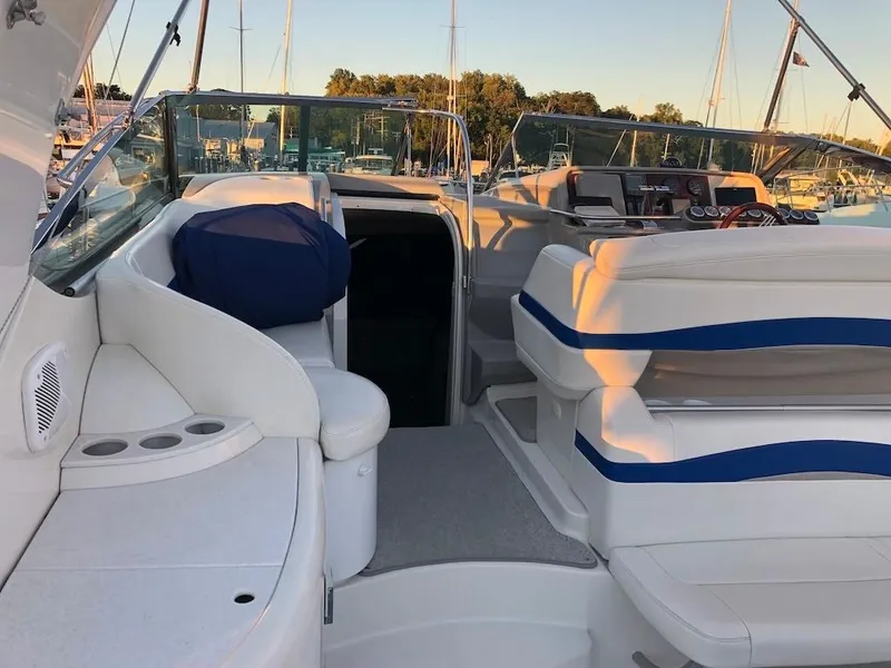 Slide: The Image of 2001 Formula 40 Performance Cruiser interior with white seating and blue accents, docked at marina. - 5