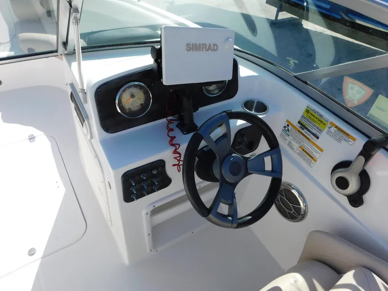 Slide: The Image of 2015 Hurricane SunDeck 187 OB boat dashboard with steering wheel and Simrad navigation system. - 13