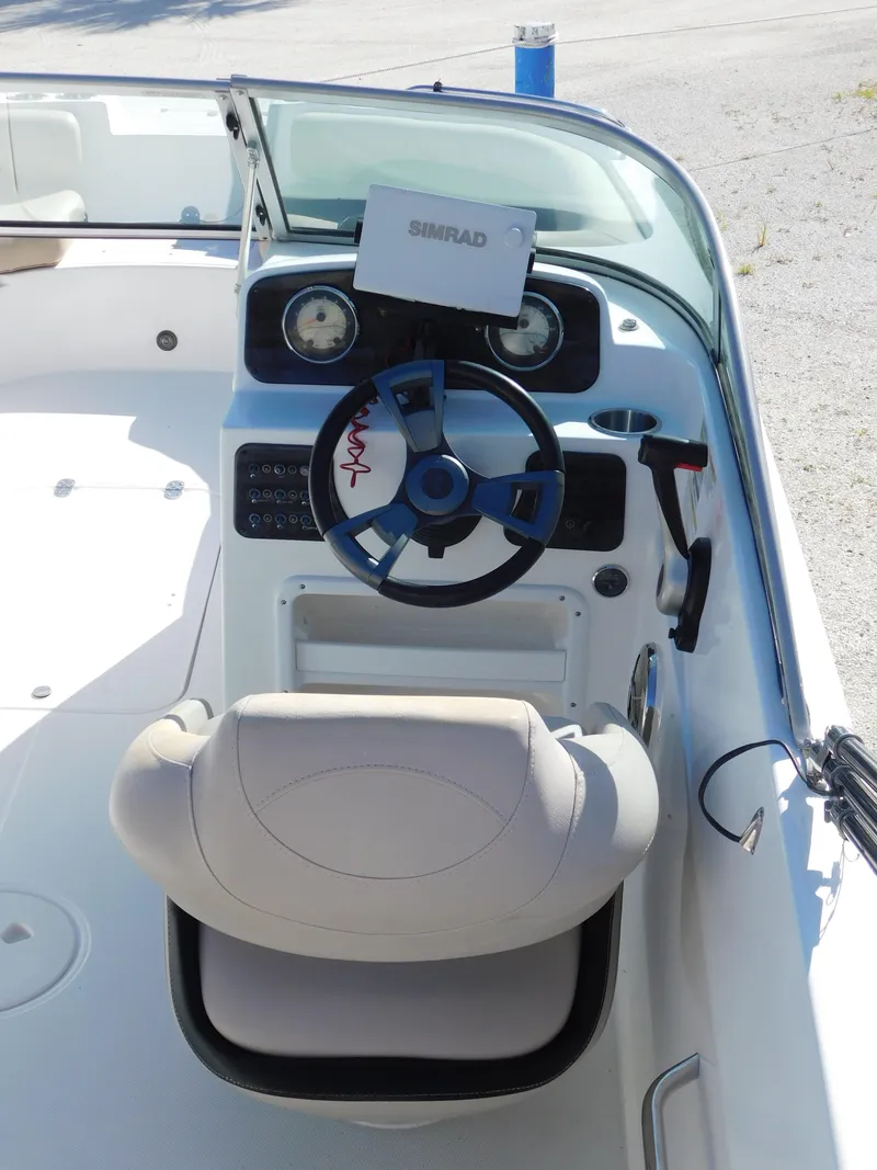 Slide: The Image of 2015 Hurricane SunDeck 187 OB boat cockpit with steering wheel and navigation system. - 14
