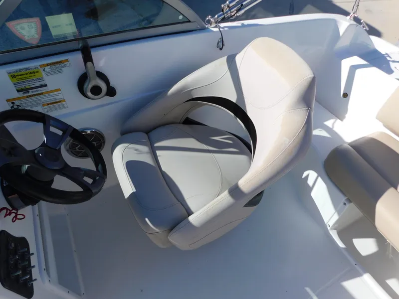 Slide: The Image of 2015 Hurricane SunDeck 187 OB boat interior with steering wheel and seating. - 15