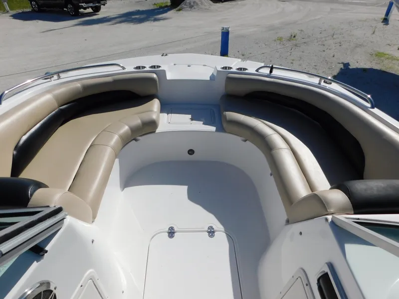 Slide: The Image of 2015 Hurricane SunDeck 187 OB boat interior with beige seating and spacious layout. - 17