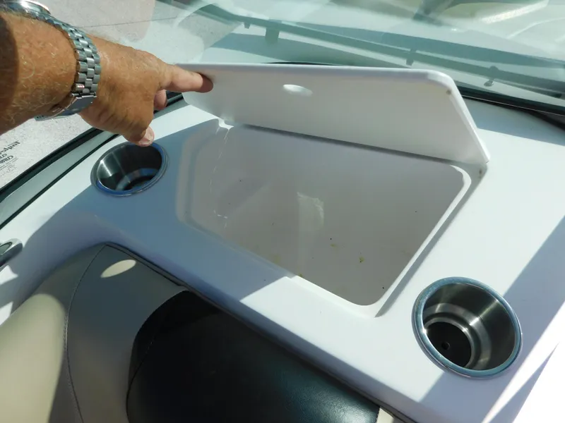 Slide: The Image of 2015 Hurricane SunDeck 187 OB boat storage compartment with cup holders. - 19
