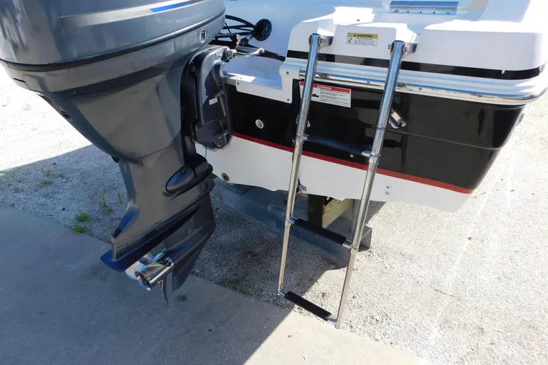 Slide: The Image of 2015 Hurricane SunDeck 187 OB boat with outboard motor and swim ladder. - 21