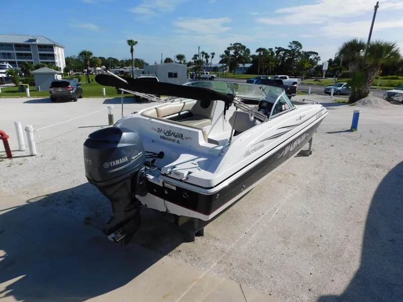 Slide: The Image of 2015 Hurricane SunDeck 187 OB boat with Yamaha outboard motor in a sunny marina. - 3