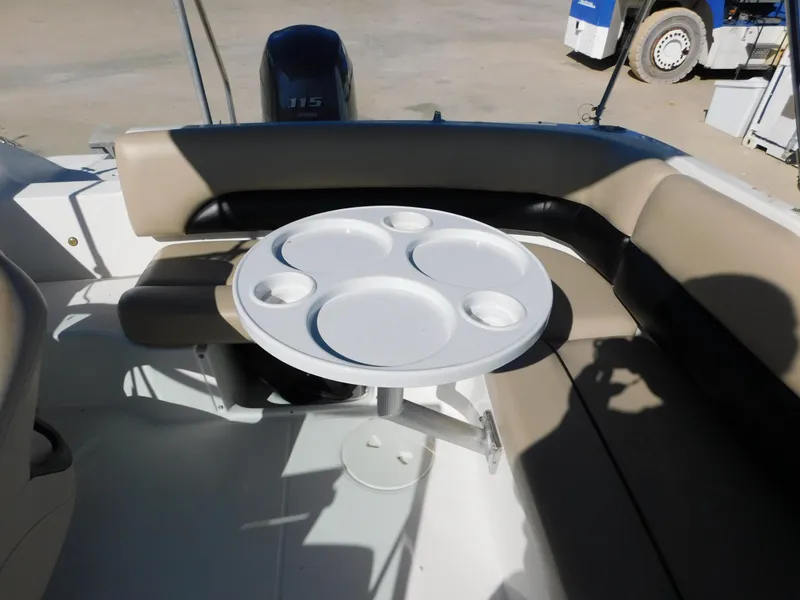 Slide: The Image of 2015 Hurricane SunDeck 187 OB boat interior with round table and seating. - 9