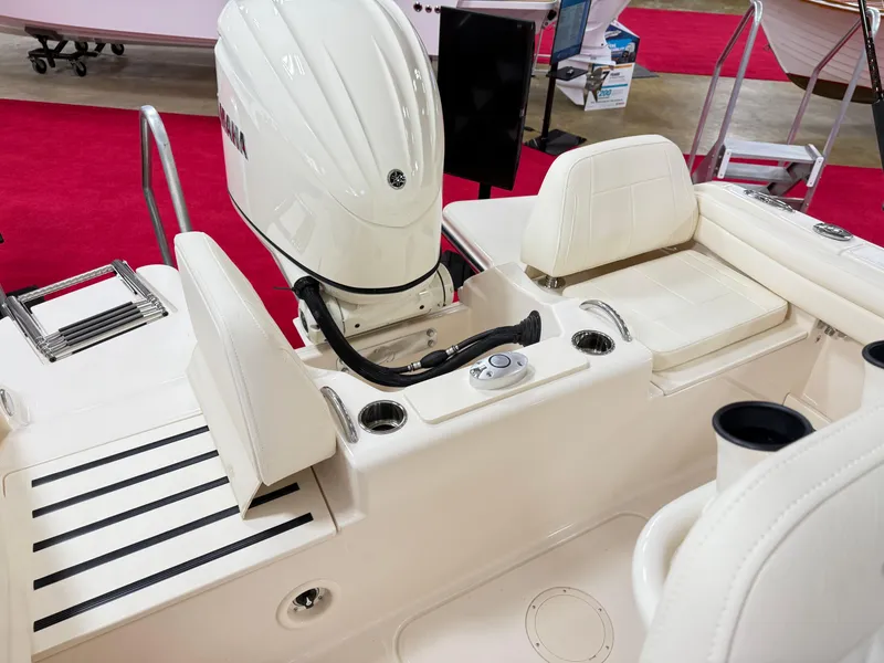 Slide: The Image of 2025 Grady-White Fisherman 216 boat interior with Yamaha engine, white seating, and cup holders. - 10