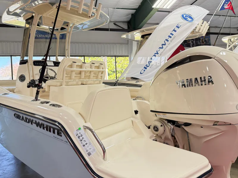 Slide: The Image of 2025 Grady-White Fisherman 216 boat with Yamaha engine displayed indoors. - 2