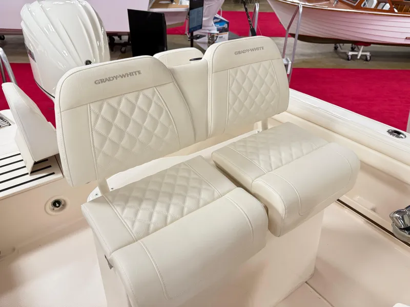 Slide: The Image of 2025 Grady-White Fisherman 216 boat seats with quilted upholstery at a showroom. - 5