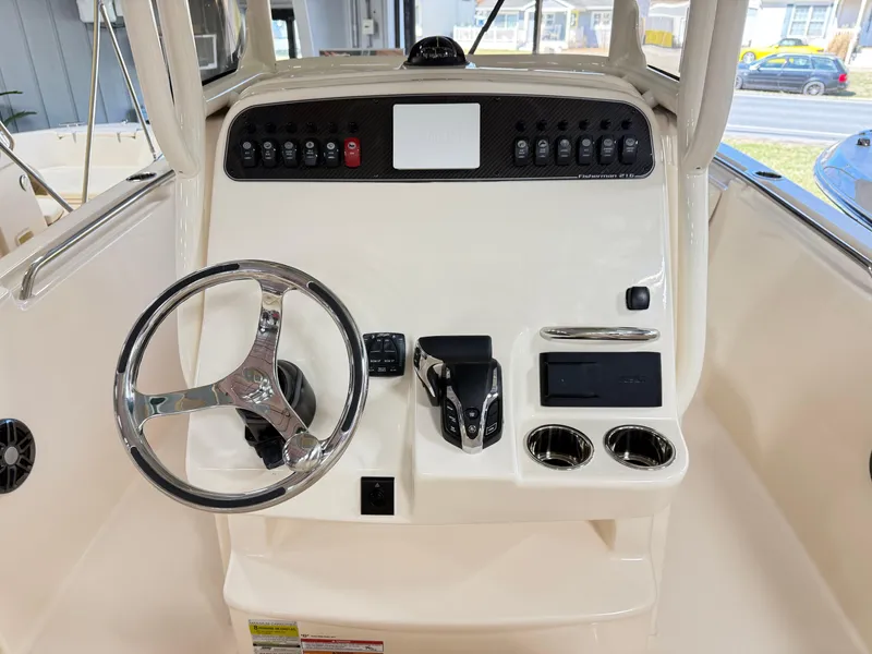 Slide: The Image of 2025 Grady-White Fisherman 216 boat console with steering wheel and control panel. - 6
