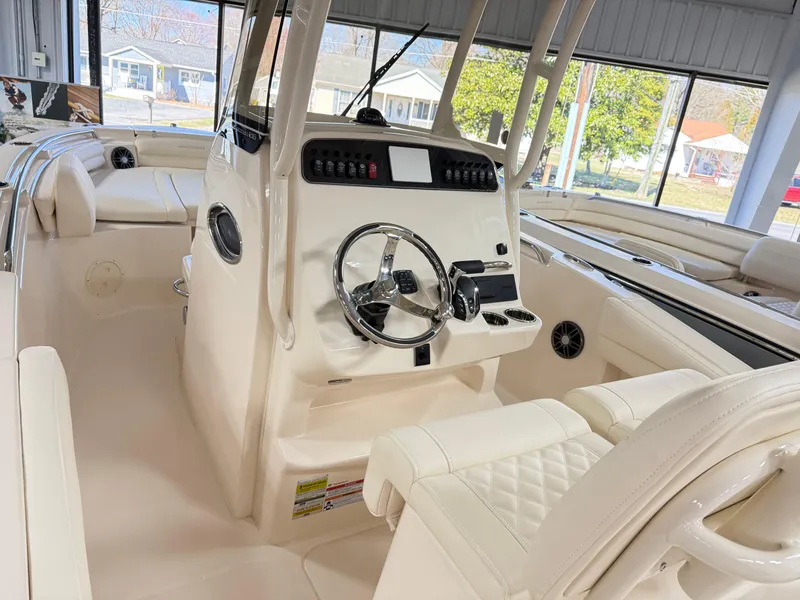 Slide: The Image of 2025 Grady-White Fisherman 216 boat interior with steering console and seating. - 7