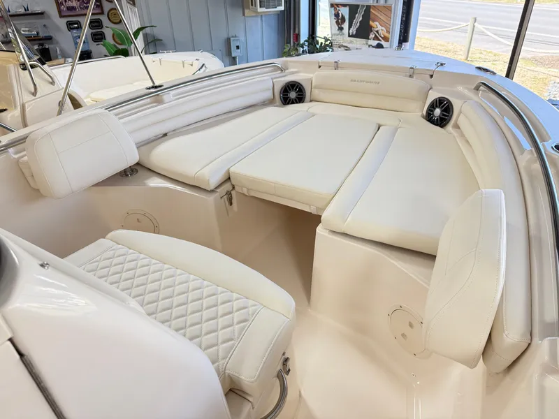 Slide: The Image of 2025 Grady-White Fisherman 216 boat interior with white cushioned seating and speakers. - 9