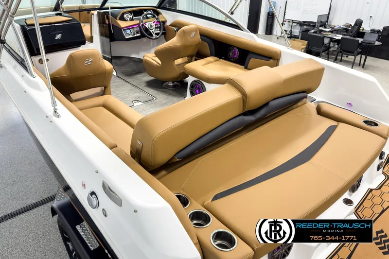 Slide: The Image of 2025 Four Winns HD3 boat interior with tan seating and modern dashboard. - 11