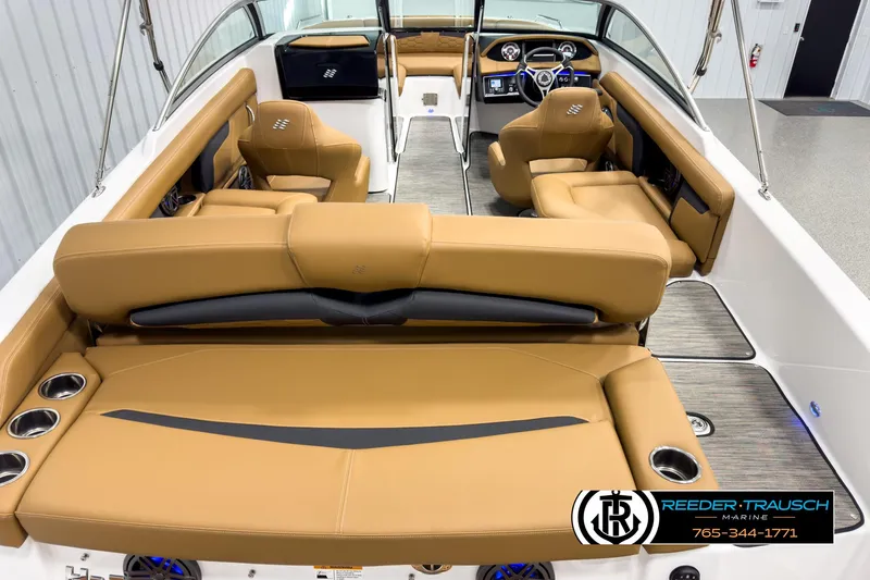 Slide: The Image of 2025 Four Winns HD3 boat interior with tan leather seating and modern dashboard. - 13