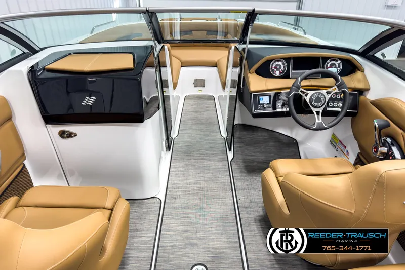 Slide: The Image of 2025 Four Winns HD3 boat interior with tan leather seats and modern dashboard. - 15