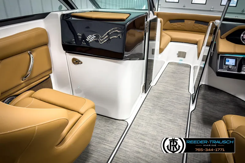 Slide: The Image of 2025 Four Winns HD3 boat interior with tan leather seating and modern dashboard. - 23