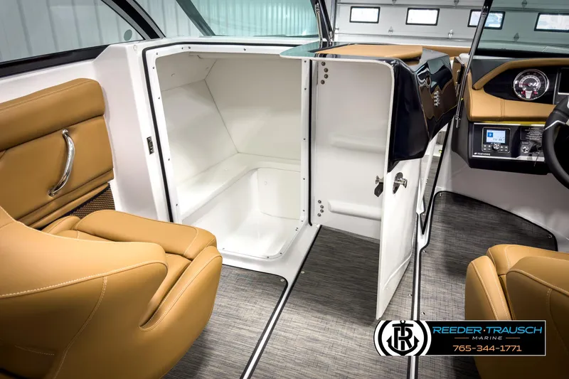 Slide: The Image of 2025 Four Winns HD3 boat interior with tan seating and open storage compartment. - 24