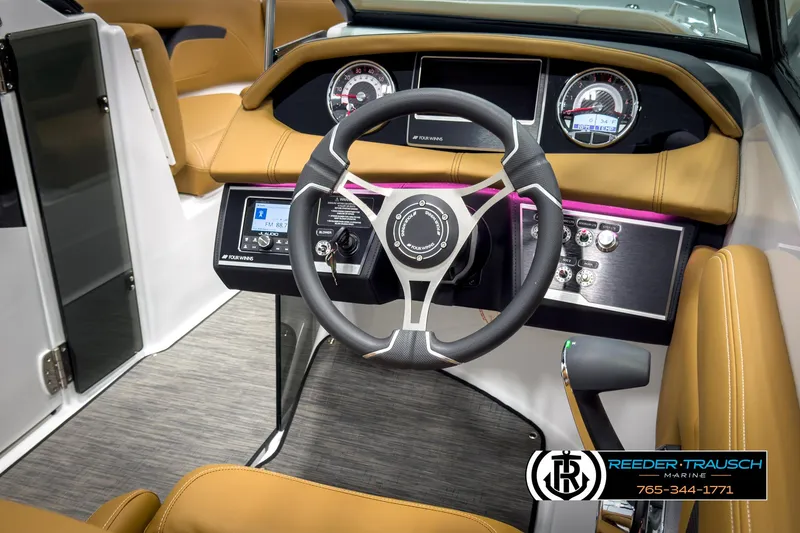 Slide: The Image of 2025 Four Winns HD3 boat dashboard with steering wheel and control panel. - 29