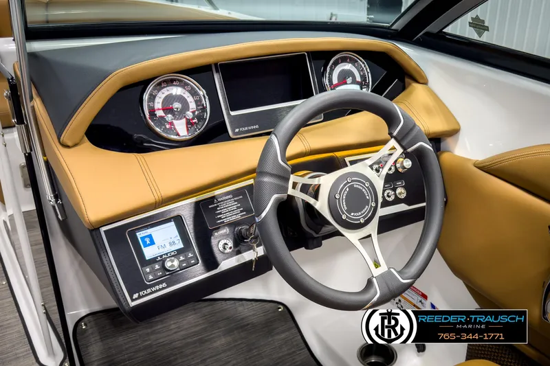 Slide: The Image of 2025 Four Winns HD3 boat dashboard with modern steering wheel and control panel. - 30