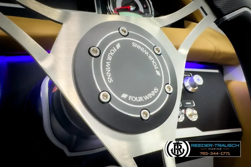 Slide: The Image of Steering wheel of 2025 Four Winns HD3 boat with dashboard controls. - 31