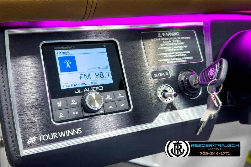 Slide: The Image of Dashboard of 2025 Four Winns HD3 boat with JL Audio system and ignition keys. - 32