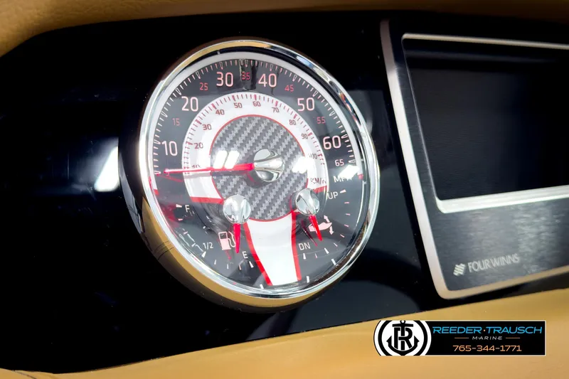 Slide: The Image of Dashboard of 2025 Four Winns HD3 boat with speedometer and carbon fiber design. - 33