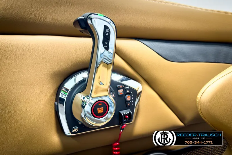 Slide: The Image of 2025 Four Winns HD3 boat throttle control with start/stop button, tan interior. - 36