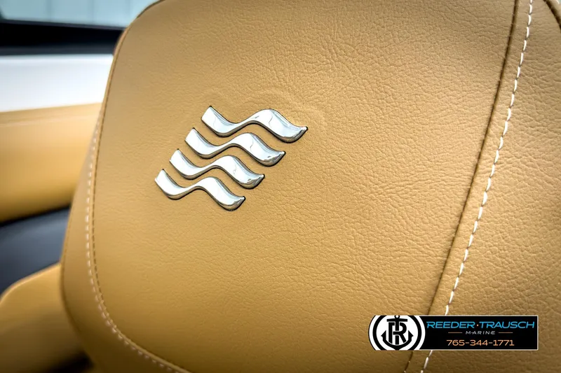 Slide: The Image of 2025 Four Winns HD3 boat seat with logo, featuring tan leather and detailed stitching. - 40