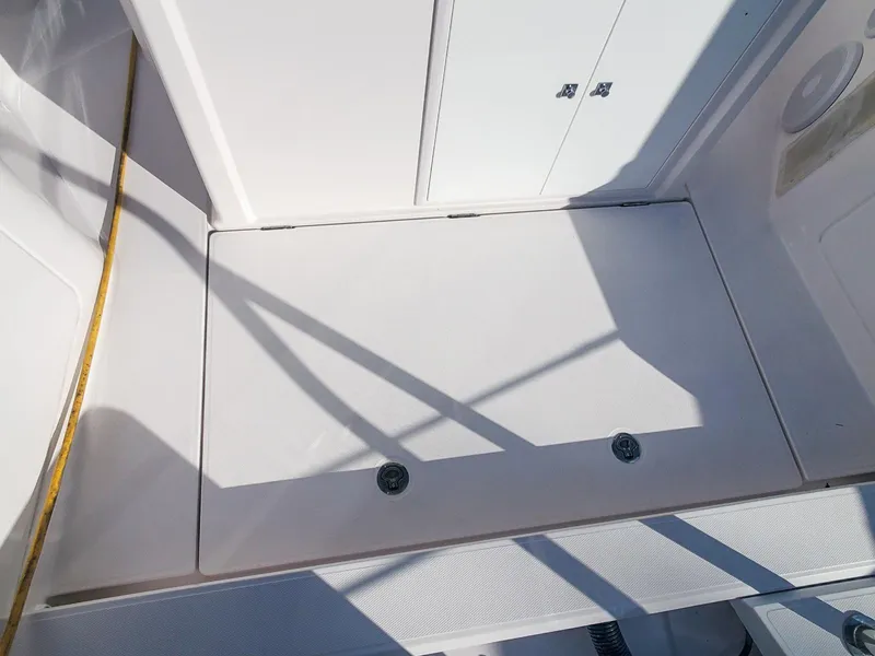 Slide: The Image of Axopar 28 CABIN 2021 boat deck with storage compartment and clean white surface. - 23